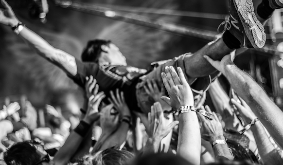 guy crowdsurfing at a concert